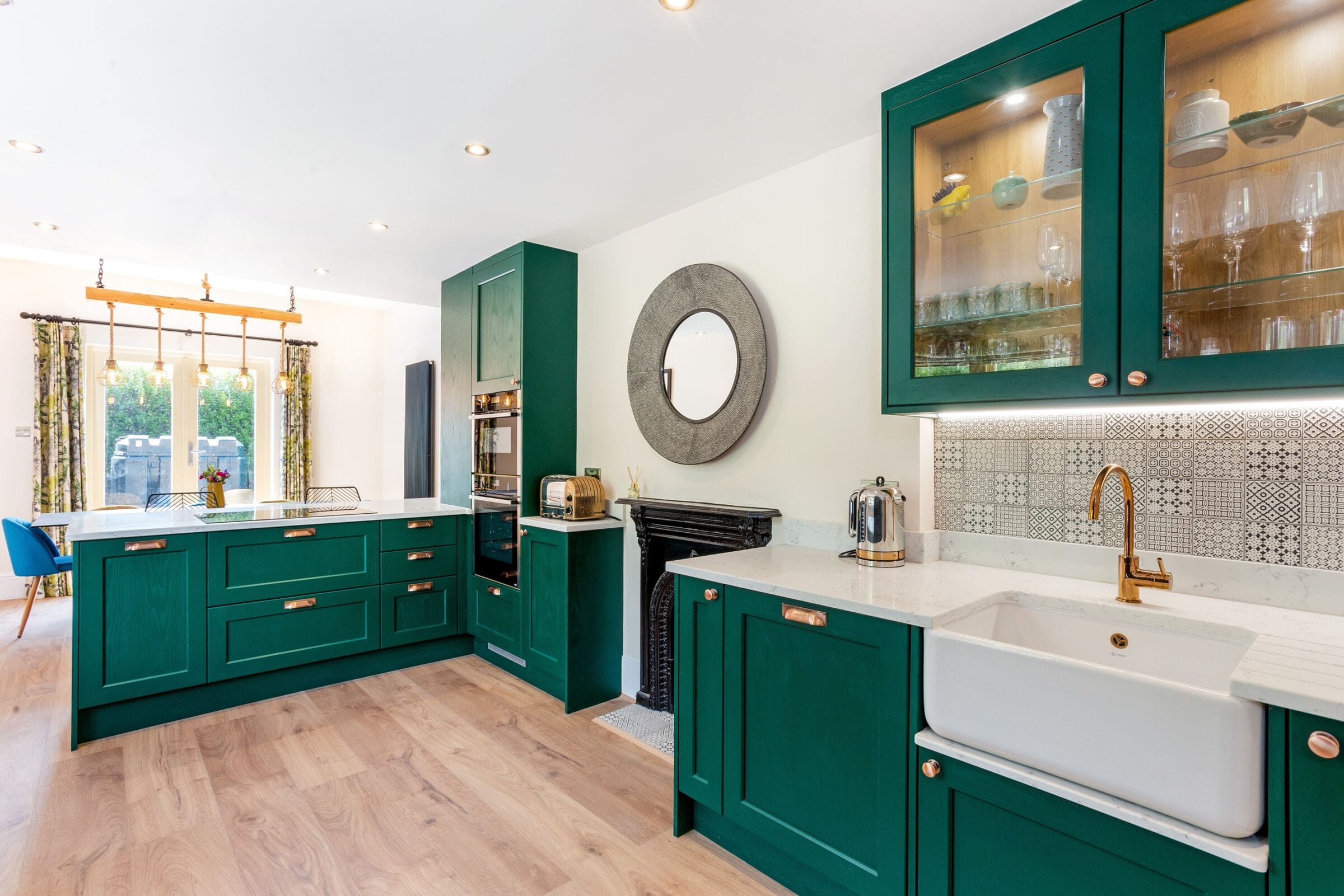 Elegant green Kitchen Living kitchen with marble worktops, glass wall cabinets, herringbone flooring and bright open-plan layout