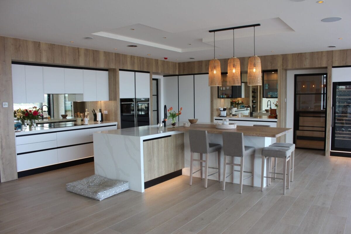 Semi-open kitchen layout with island, wood finishes and defined cooking and dining zones