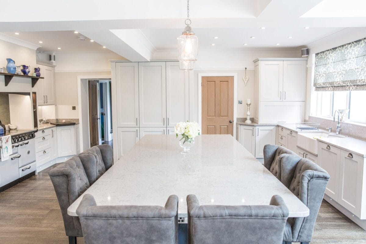 Classic shaker kitchen with large dining island and painted cabinetry by Kitchen Living