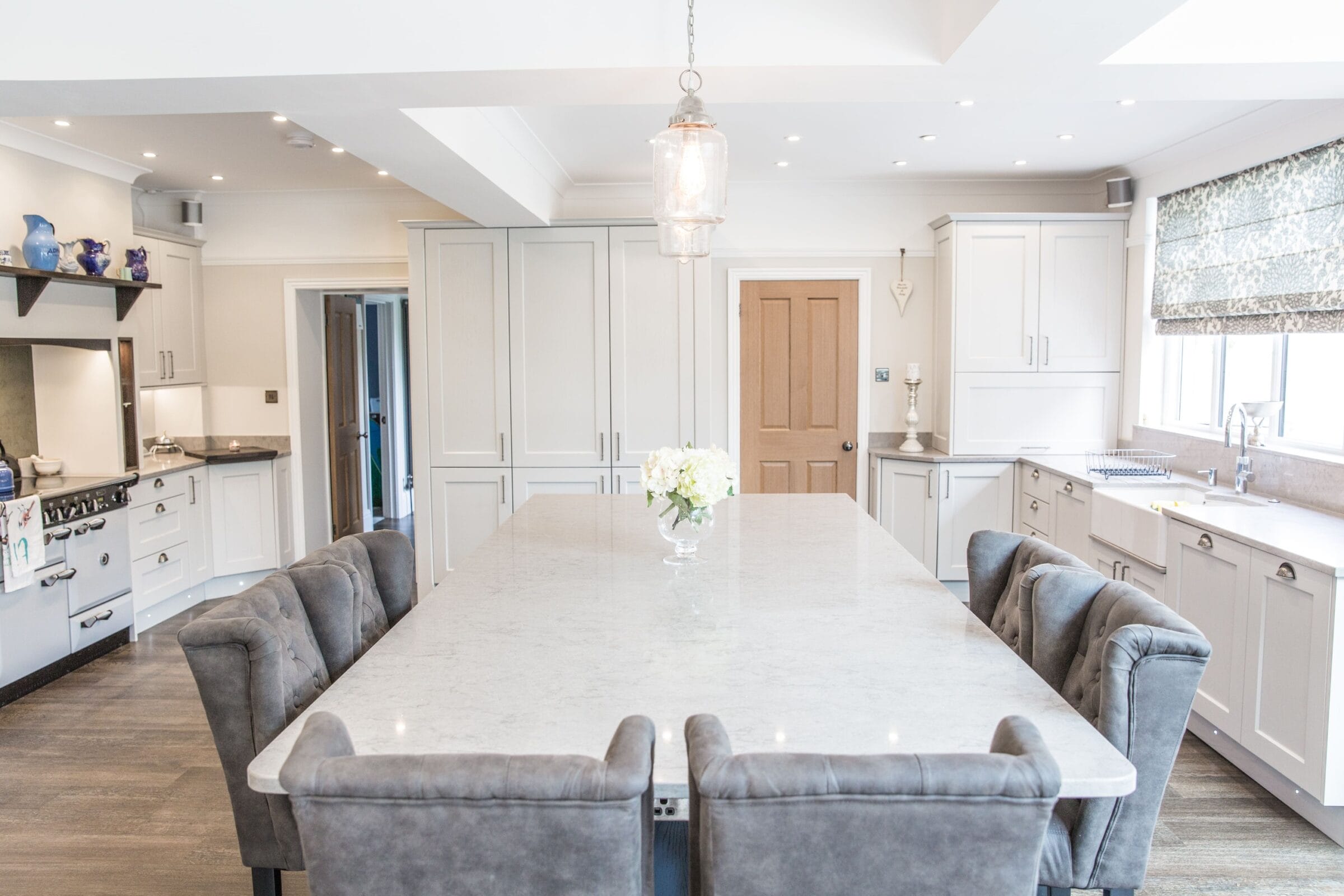 Open-plan Kitchen Living kitchen with marble island, grey cabinetry, pendant lighting and spacious dining area