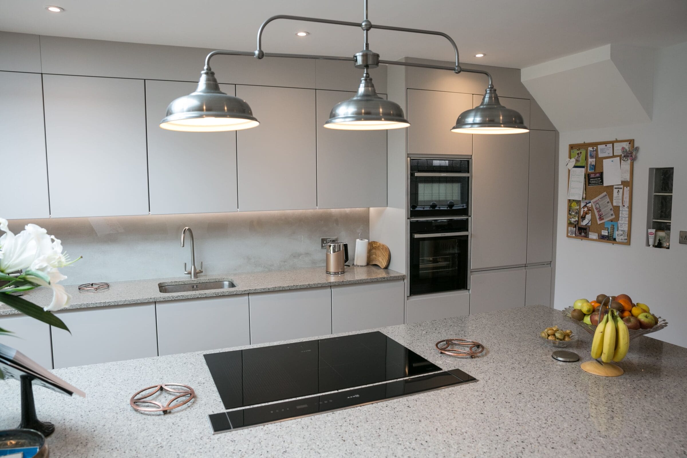 Warm grey in-frame shaker kitchen with integrated American fridge freezer, marble worktop and parquet flooring by Kitchen Living
