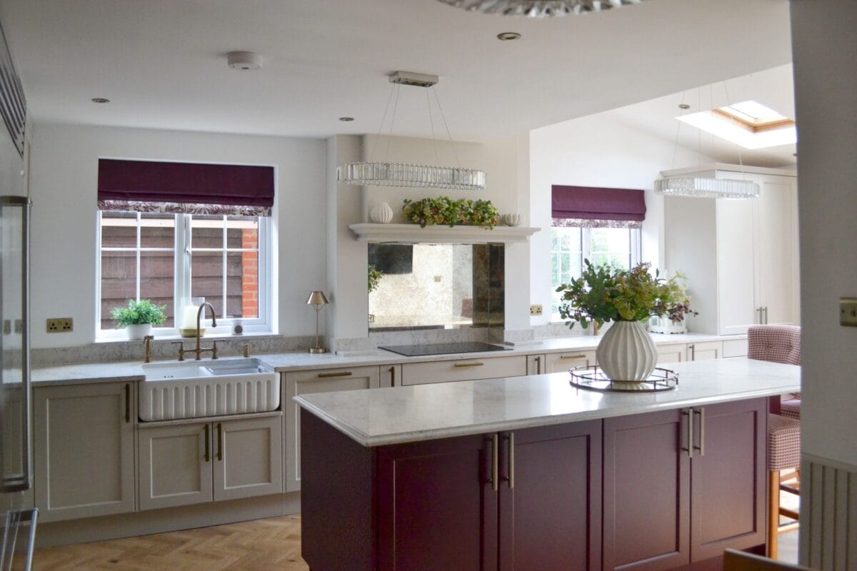 Traditional Kitchen Living kitchen with burgundy island, white cabinetry, marble worktops and bright open-plan dining space